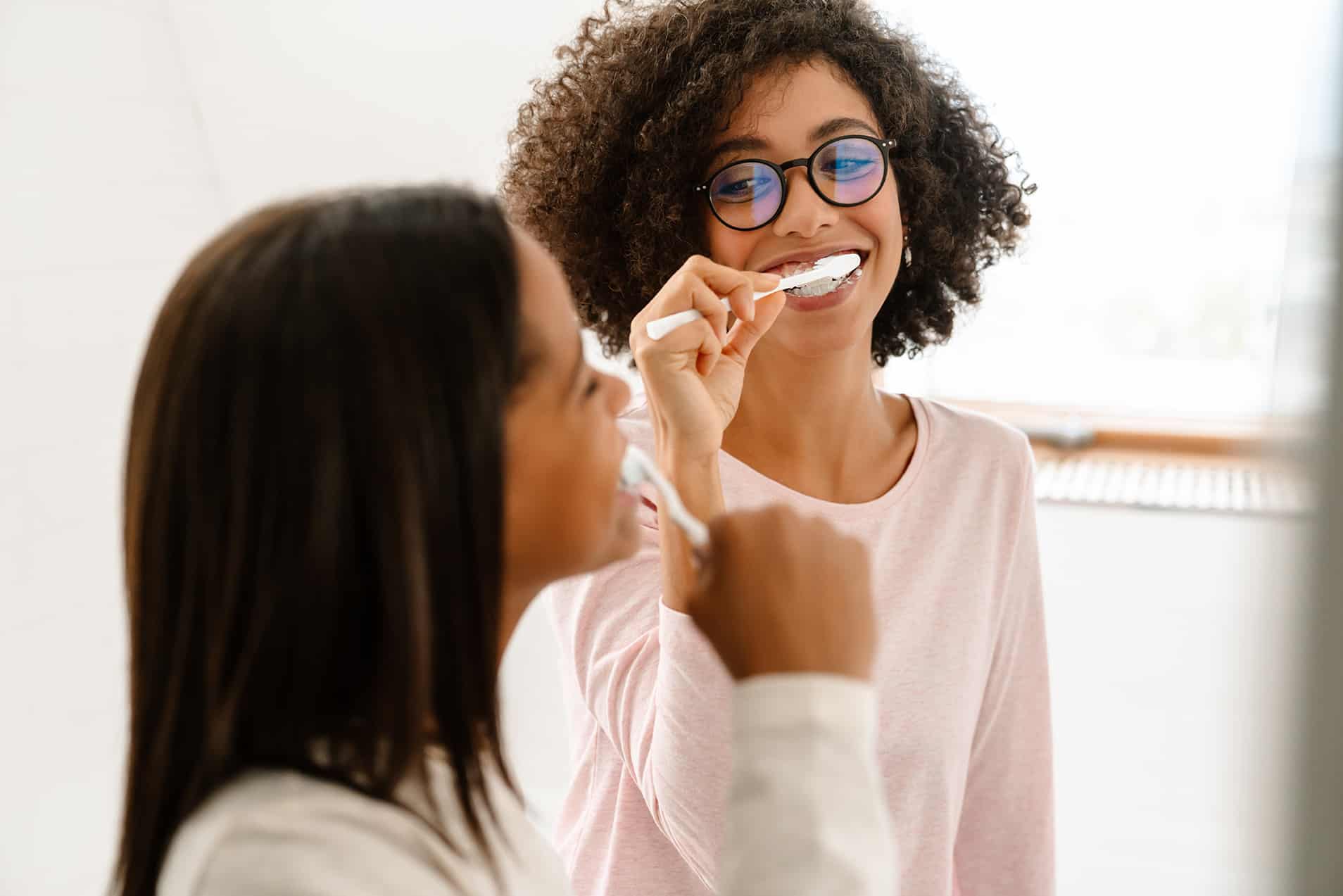 mother and daughter brushing their teeth in noblesville in